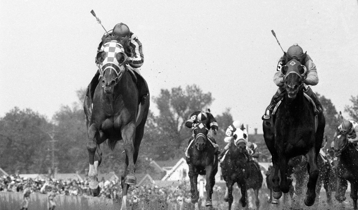 Ron Turcotte aboard Secretariat (left) edges ahead of Laffit Pincay Jr. aboard Sham (right) near the finish of the 99th Kentucky Derby at Churchill Downs.