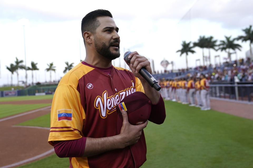 Venezuela's pitcher Martin Perez sings the Venezuelan national anthem before an exhibition baseball game between Venezuela and the Houston Astros, Wednesday, March 8, 2023, in West Palm Beach, Fla. (AP Photo/Lynne Sladky)