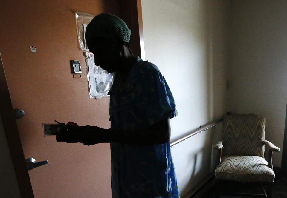 Janet Arnett looks for her keys as she prepares to lock her apartment door in Epiphany House, a low-income senior home in Baltimore, Tuesday, July 3, 2012, as she awaits return of electricity for the first time since last weekend's severe storms. Utility crews struggled Tuesday to restore power to more than 1 million people in the eastern U.S. as frustration grew four days after storms that have led to 24 deaths so far. Officials worried the toll could rise because of stifling conditions and generator fumes. (AP Photo/Patrick Semansky)