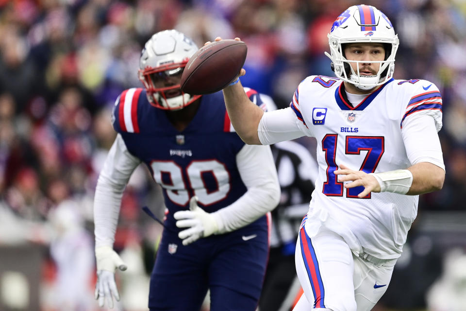 FOXBOROUGH, MASSACHUSETTS - DECEMBER 26: Josh Allen #17 of the Buffalo Bills looks to throw the ball as Christian Barmore #90 of the New England Patriots applies pressure during the first quarter at Gillette Stadium on December 26, 2021 in Foxborough, Massachusetts. (Photo by Maddie Malhotra/Getty Images)