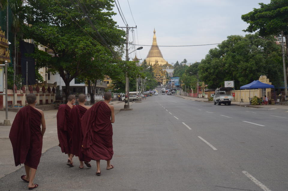 Young Buddhist monks walk on a road leading to the Shwedagon Pagoda in Yangon, Myanmar Friday, April 16, 2021. Opponents of Myanmar's ruling junta went on the political offensive Friday, declaring they have formed an interim National Unity Government comprising elements of the ousted government of Aung San Suu Kyi as well as prominent members of major ethnic minority groups. (AP Photo)