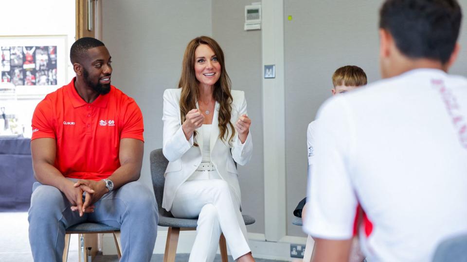 Catherine, Duchess of Cambridge (C) makes a visit to SportsAid House on day five of the Commonwealth Games in Birmingham
