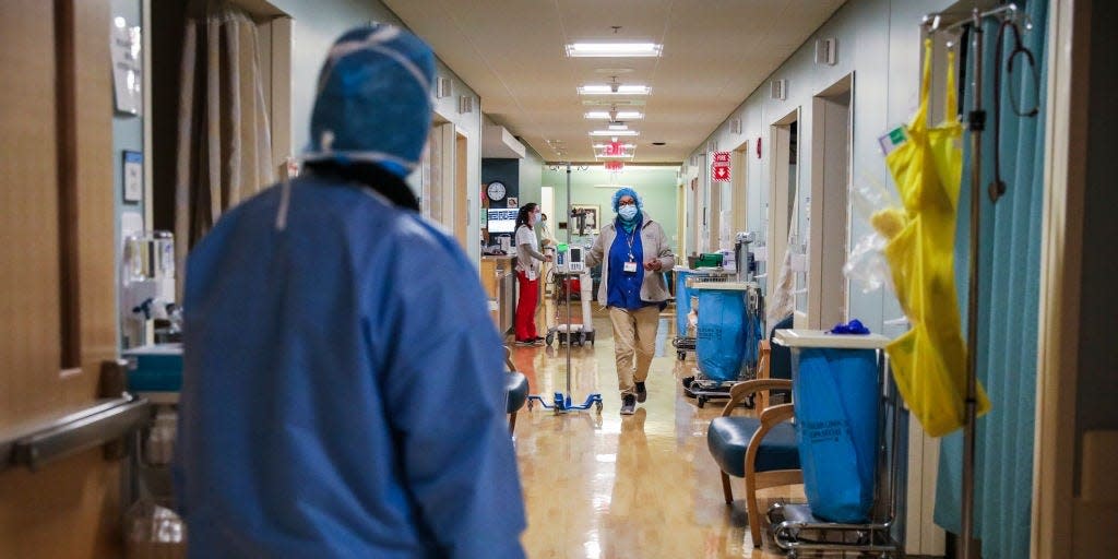 Hospitals hallway with healthcare workers