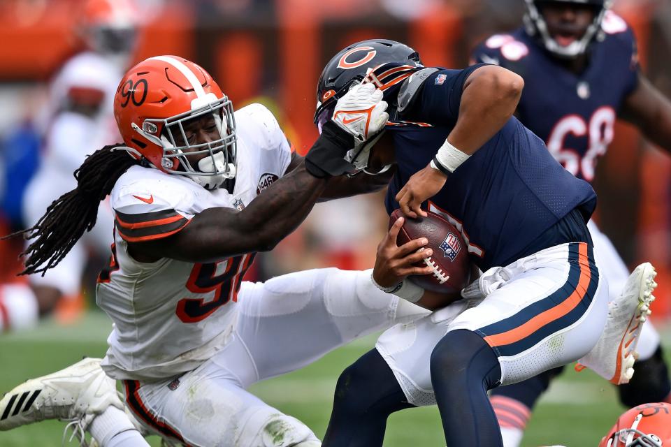 Browns defensive end Jadeveon Clowney, left, sacks Bears quarterback Justin Fields during the second half Sunday, Sept. 26, 2021, in Cleveland. (AP Photo/David Richard)