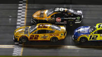 Joey Logano (22) edges Christopher Bell (20) to win the first NASCAR Daytona 500 qualifying auto race Thursday, Feb. 16, 2023, at Daytona International Speedway in Daytona Beach, Fla. Finishing third is Ryan Blaney (12). (AP Photo/Chris O'Meara)