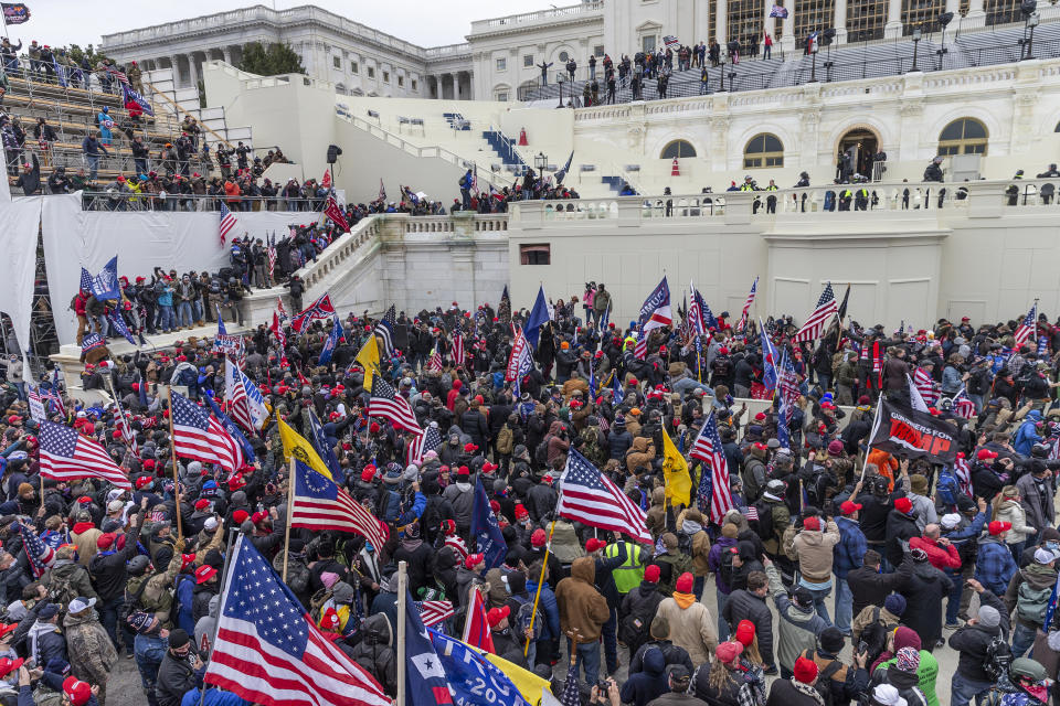 Pro-Trump protesters seen on and around Capitol building. Rioters broke windows and breached the Capitol building in an attempt to overthrow the results of the 2020 election. Police used batons and tear gas grenades to eventually disperse the crowd. Rioters used metal bars and tear gas as well against the police. 