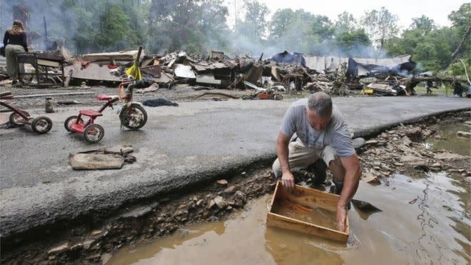 Residents clean up after the floods. Photo: AP