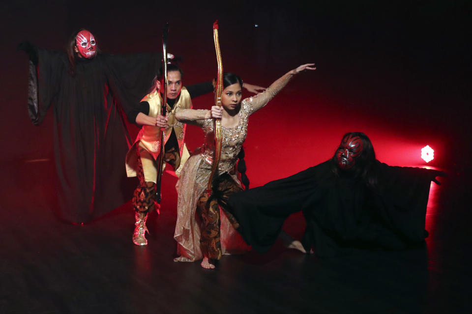 Indonesian dancers Nala Amyrtha, center, and Siswanto "Kojack" Kodrata, second from left, perform during a video recording for '"Saweran Online" program on Indonesia Dance Network YouTube channel, at EKI Dance Company studio in Jakarta, Indonesia Thursday, May 14, 2020. Two Indonesian choreographers are helping fellow dancers who lost their jobs due to the new coronavirus outbreak in the country by setting up aYouTube channel as a platform where dancers, choreographers and dance teachers can perform, then receive donation from viewers. (AP Photo/Achmad Ibrahim)
