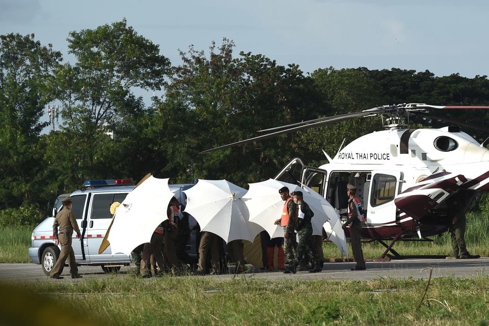 One of the boys is seen being moved from an ambulance to a helicopter to be airlifted to hospital. Source: Getty