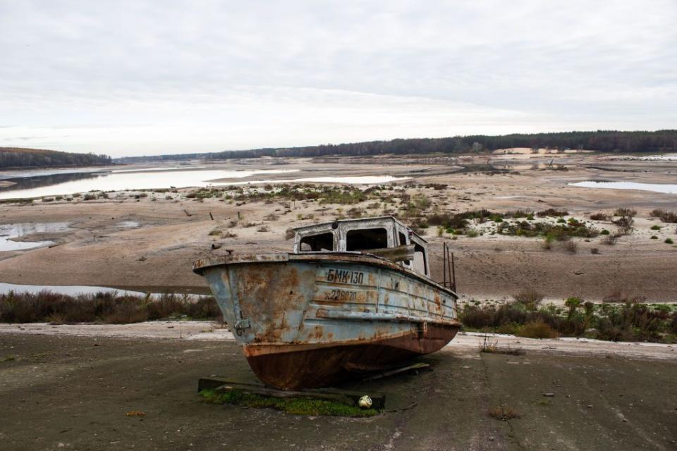 An abandoned boat lies near the empty Oskil reservoir on Oct. 27, 2022, in Kharkiv Oblast, Ukraine. Oskil reservoir. At the height of Russian attacks in the spring of 2022, the dam on the Oskil was partially blown up. (Photo by Mariia Solodovnyk/Suspilne Ukraine/JSC "UA:PBC"/Global Images Ukraine via Getty Images)