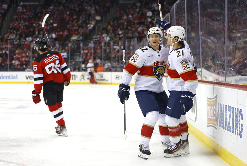 Florida Panthers center Nick Cousins (21) celebrates with Florida Panthers defenseman Gustav Forsling (42) after scoring a goal against the New Jersey Devils during the first period of an NHL hockey game, Tuesday, March 5, 2024, in Newark, N.J. (AP Photo/Noah K. Murray)