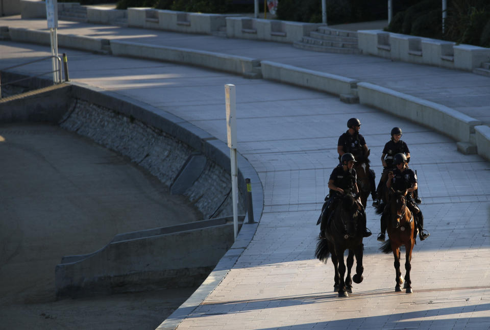 Mounted police officers patrol along the beach, Saturday, Aug. 24, 2019 in Biarritz. Leaders of the Group of Seven countries arrive on Saturday to discuss issues including the struggling global economy and climate change until Monday. They include the United States, Germany, Japan, Britain, France, Canada and Italy. (AP Photo/Francois Mori)