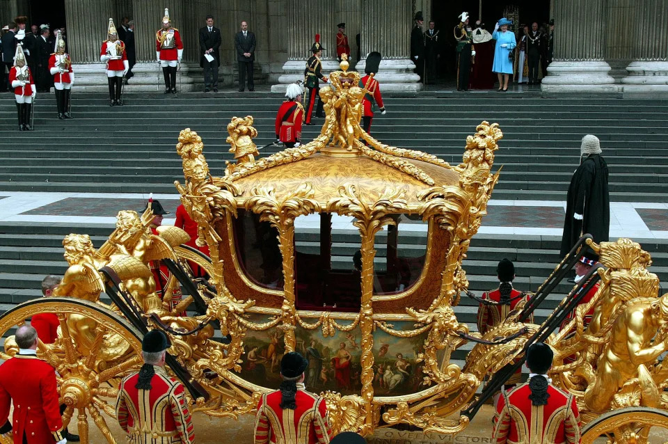 BRITAIN'S QUEEN ELIZABETH II WAVES TO THE CROWDS AT ST. PAUL'S
CATHEDRAL AHEAD OF THE GOLDEN JUBILEE SERVICE OF THANKSGIVING IN
LONDON.

	
Britain's Queen Elizabeth II (in blue) waves to the crowds from the
entrance of St. Paul's Cathedral after arriving by the Coronation
Carriage for the Golden Jubilee Service of Thanksgiving in London June
4, 2002. Thousands of people gathered in central London for the
festivities on the final day of the celebratory weekend marking the
Queen's 50th year on the throne. The golden coach was first seen in
public in 1762, when King George III travelled to the state opening of
parliament. It cost a hefty 7,562 pounds to make, the equivalent of
over $1 million today. It was last used at the Queen's Silver Jubilee
in 1977. REUTERS/Stephen Hird