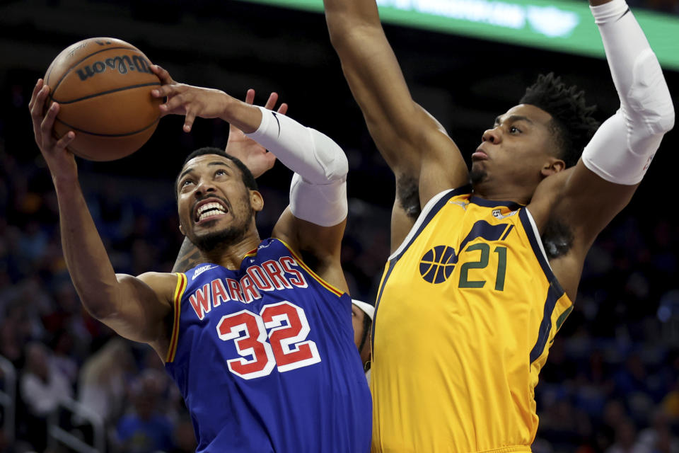 Golden State Warriors forward Otto Porter Jr. (32) shoots against Utah Jazz center Hassan Whiteside (21) during the first half of an NBA basketball game in San Francisco, Saturday, April 2, 2022. (AP Photo/Jed Jacobsohn)