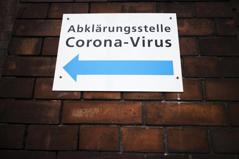 An information sign displayed at the wall of an hospital directing to a new set up test and information centre for the new coronavirus at the district Prenzlauer Berg in Berlin, Germany, Monday, March 9, 2020 (AP Photo/Markus Schreiber)