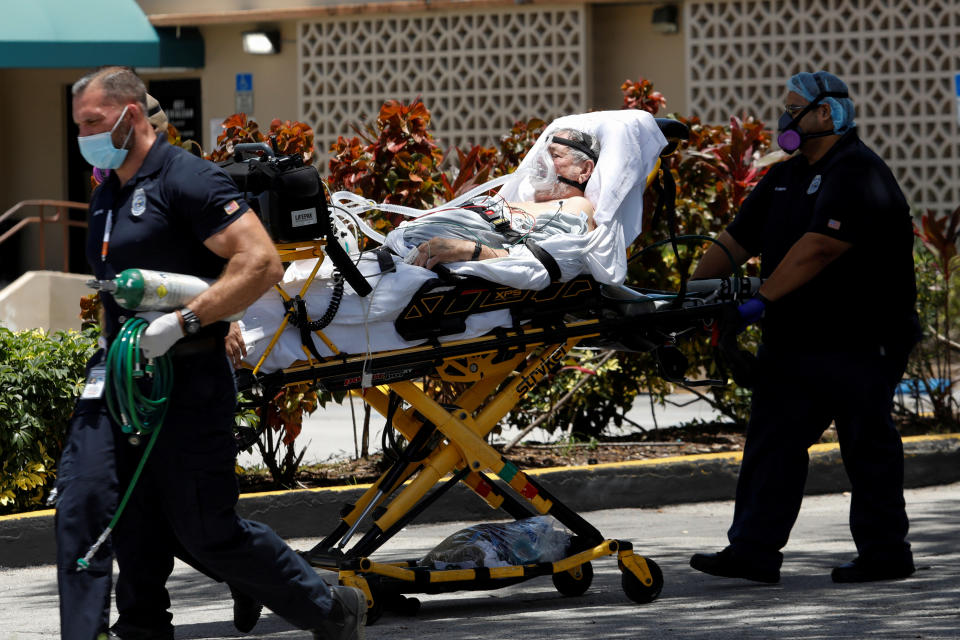 Emergency Medical Technicians (EMT) leave with a patient at Hialeah Hospital where the coronavirus disease (COVID-19) patients are treated, in Hialeah, Florida, U.S., July 29, 2020. REUTERS/Marco Bello     TPX IMAGES OF THE DAY