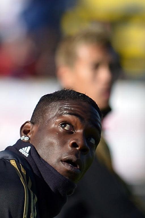 AC Milan's Mario Balotelli warms up prior an Italian Serie A match, at the Sant'Elia stadium in Cagliari, on January 26, 2014