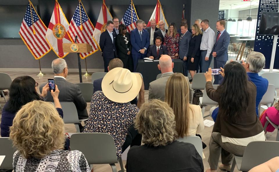 Florida Gov. Ron DeSantis signs legislation on Thursday in Jacksonville.