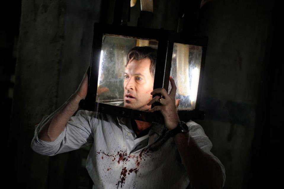 Scott Patterson in 'Saw V' with a box on his head