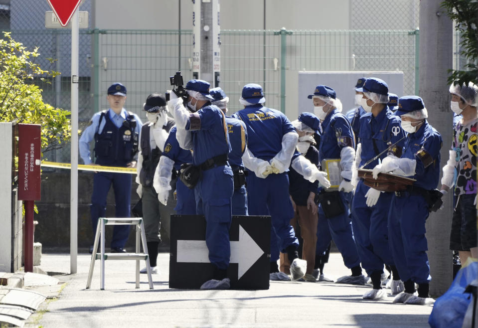 Japanese police investigators work at an area near a stabbing scene in Tokyo, Wednesday, May 10, 2023. Japanese police said a schoolboy was stabbed in the chest as he stepped out of his house to go to school Wednesday in a residential area of downtown Tokyo. A suspect was arrested at the scene. (Takaki Yajima/Kyodo News via AP)