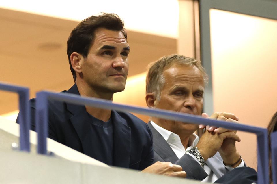 Swiss former professional tennis player Roger Federer (L) attends the women's quarterfinals match between Belarus's Aryna Sabalenka and China's Zheng Qinwen on day nine of the US Open (AFP via Getty Images)