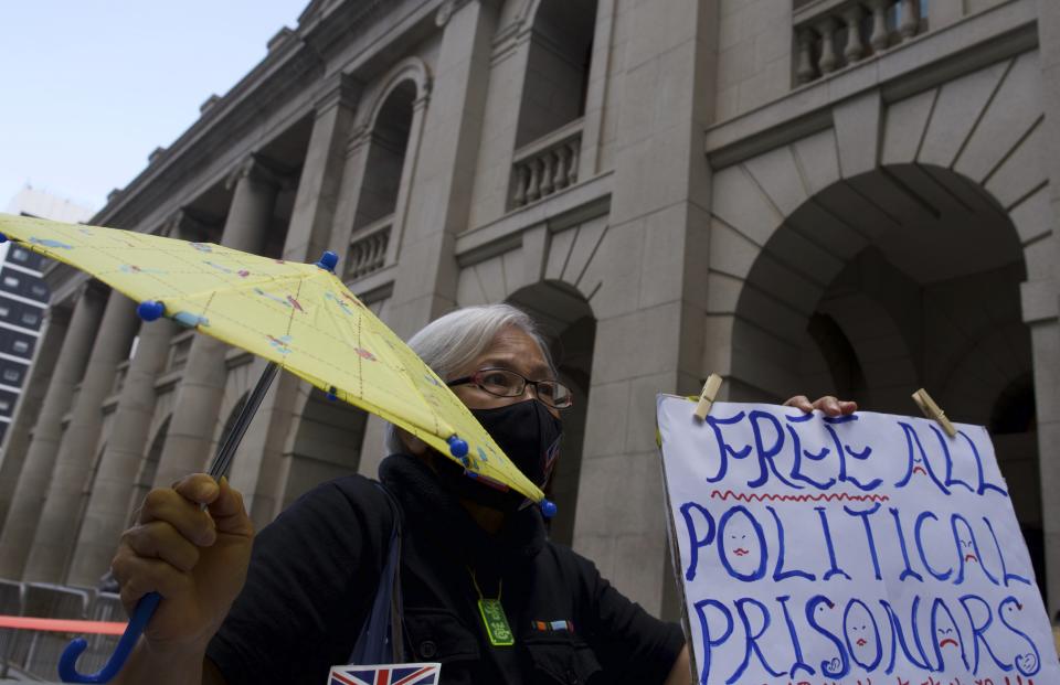 A protester displays a placard to support democracy advocate Jimmy Lai outside Hong Kong's Court of Final Appeal where the government is arguing against allowing him bail in Hong Kong Monday, Feb. 1, 2021. Lai is charged with "collusion" under the new National Security Law that Beijing imposed on Hong Kong last year. (AP Photo/Vincent Yu)