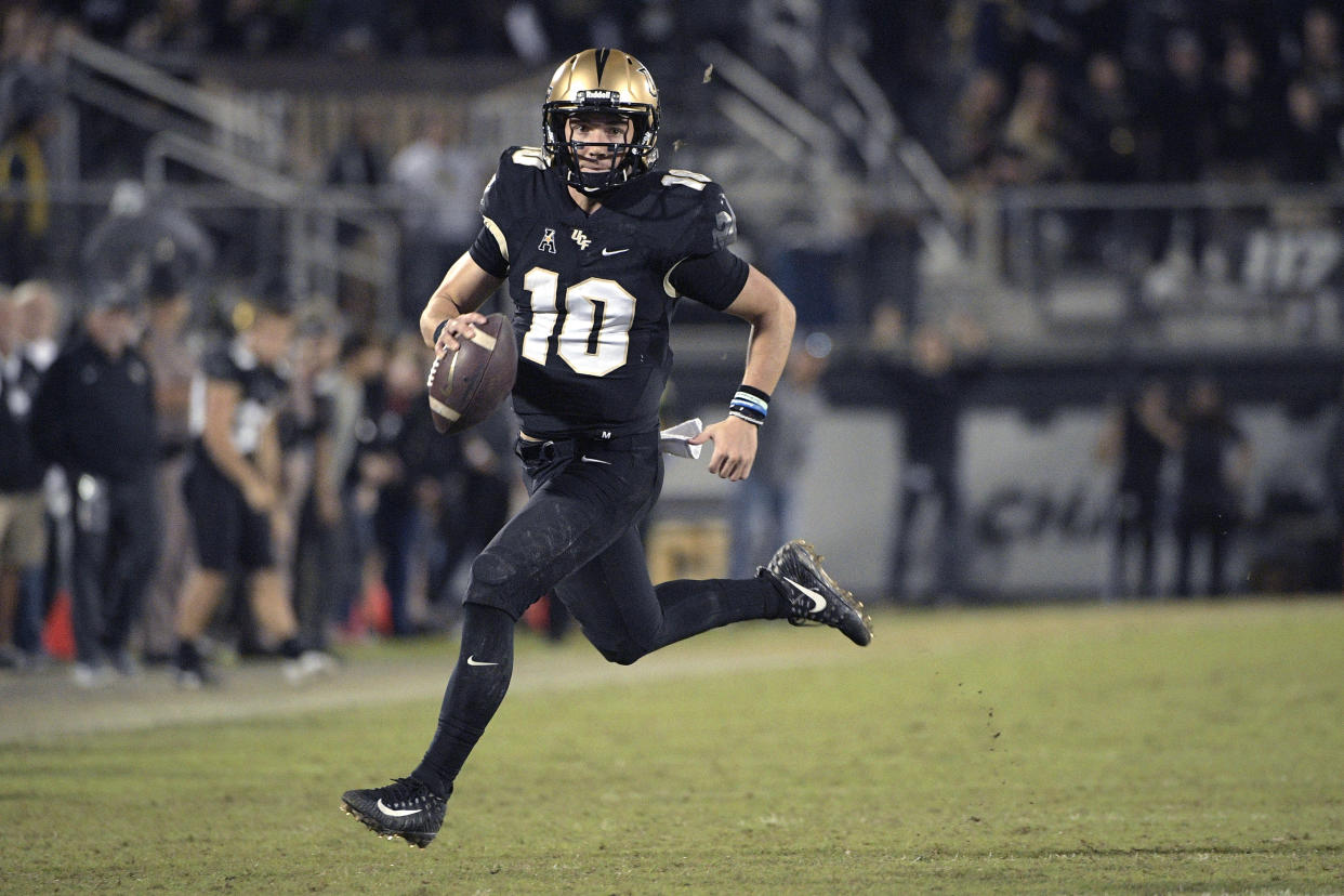 Central Florida quarterback McKenzie Milton (10) rushes for yardage during the second half of an NCAA college football game against Cincinnati Saturday, Nov. 17, 2018, in Orlando, Fla. (AP Photo/Phelan M. Ebenhack)