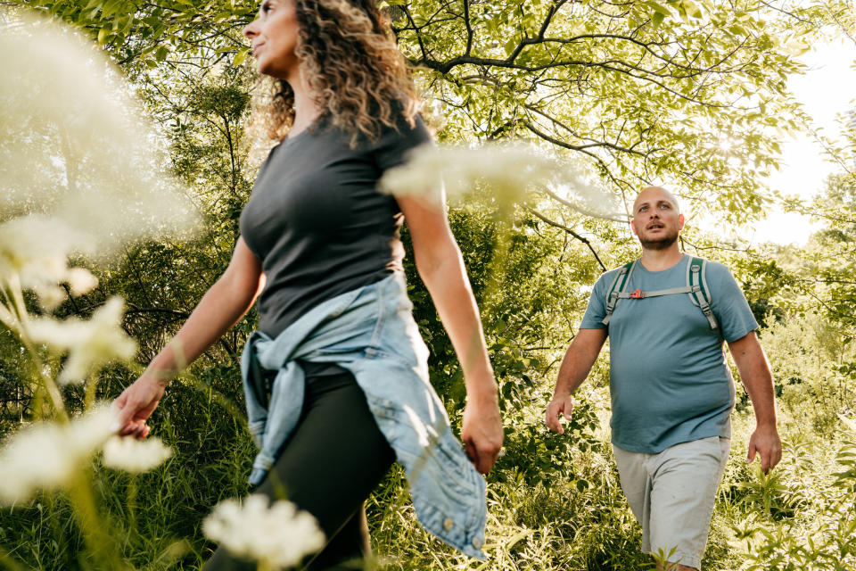 Man and woman walking through a park together