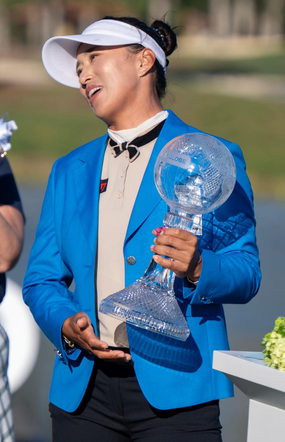 Amy Yang holds her trophy on the 18th green after winning the CME Group Tour Championship at the Tiburon Golf Club in Naples, Fla., on Sunday, November 19, 2023.