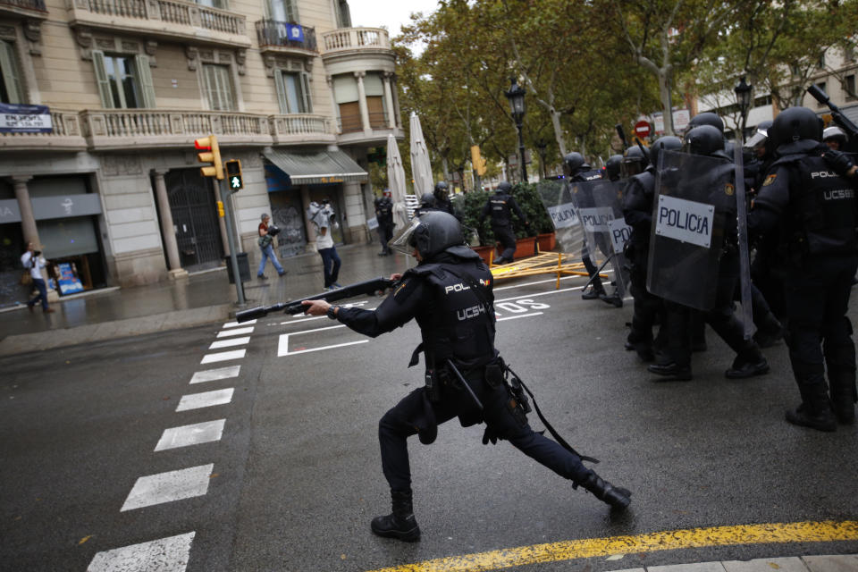 <p>Spanish riot police shoots rubber bullet straight to people trying to reach a voting site at a school assigned to be a polling station by the Catalan government in Barcelona, Spain, Oct. 1, 2017. (Photo: Emilio Morenatti/AP) </p>