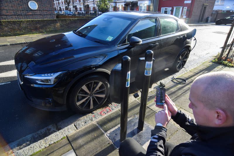 CEO Chris Pateman-Jones demonstrates Connected Kerb's smart charging app at one of the charging infrastructure company's smart public on-street chargers in the borough of Hackney, London