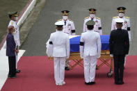 Widow and former first lady Amelita Ramos, left, with military chief Lieutenant General Bartolome Vicente Bacarro, second from left, stands beside the flag-draped casket of her husband, the late former Philippine President Fidel V. Ramos, during his state funeral at the Heroes' Cemetery in Taguig, Philippines on Tuesday Aug. 9, 2022. Ramos was laid to rest in a state funeral Tuesday, hailed as an ex-general, who backed then helped oust a dictatorship and became a defender of democracy and can-do reformist in his poverty-wracked Asian country. Ramos died at age 94. (AP Photo/Aaron Favila)