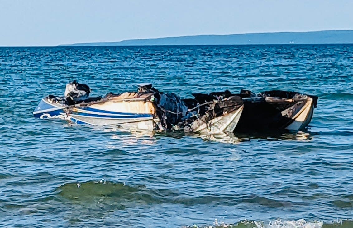 Burnt out remnants of a Boyne Thunder power boat are seen.