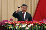 Chinese President Xi Jinping makes a toast after delivering his speech at a dinner marking the 70th anniversary of the founding of the People's Republic of China at the Great Hall of the People in Beijing, Monday, Sept. 30, 2019. Xi on Monday renewed his government's commitment to allowing Hong Kong to manage its own affairs amid continuing anti-government protests in the semi-autonomous Chinese territory. (AP Photo/Andy Wong)