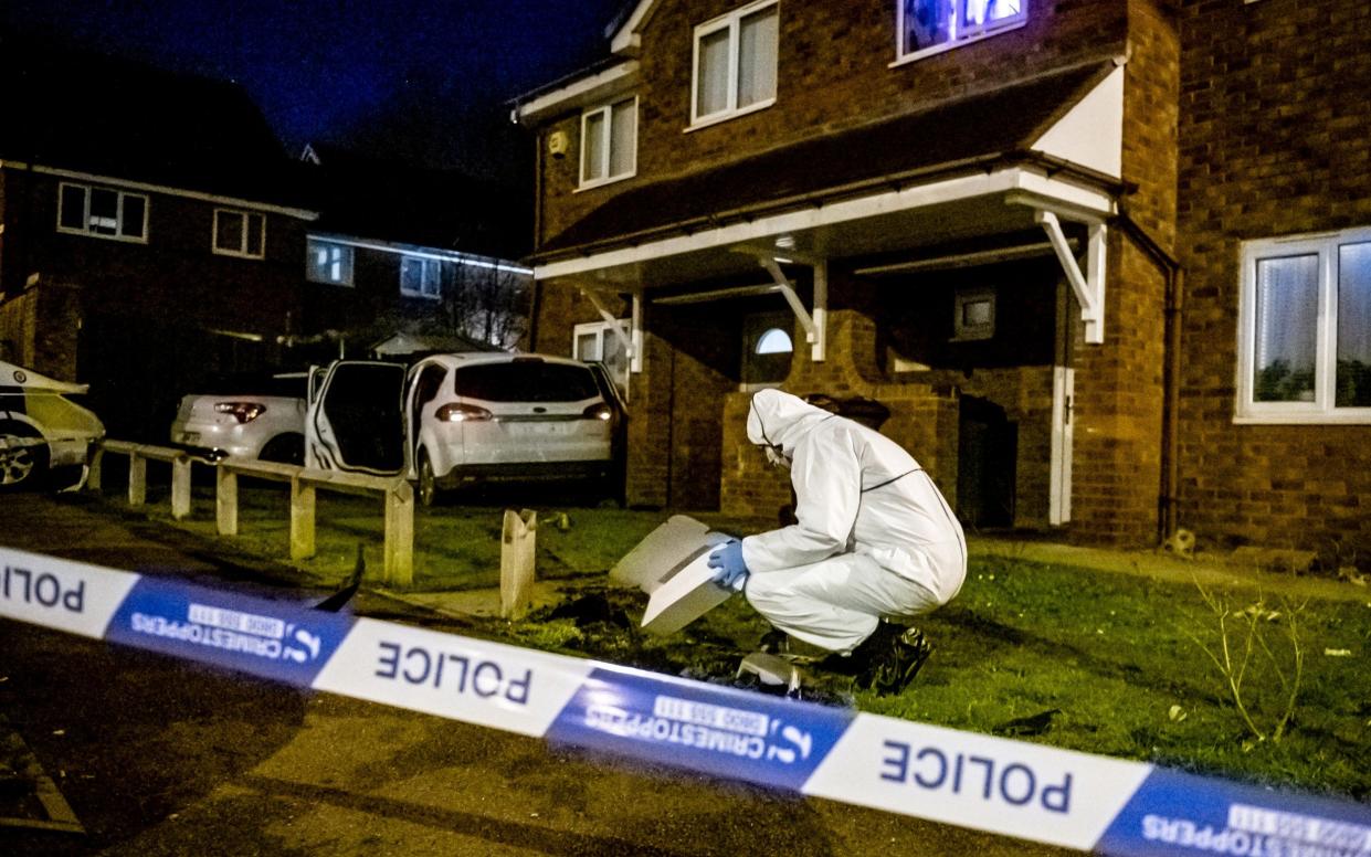 Police forensics examine the scene where a crashed getaway car was abandoned in Handsworth - Adam Hughes/SWNS