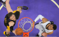 Los Angeles Lakers center Pau Gasol, left, of Spain, puts up a shot as Sacramento Kings forward Derrick Williams defends during the first half of an NBA basketball game, Friday, Feb. 28, 2014, in Los Angeles. (AP Photo/Mark J. Terrill)
