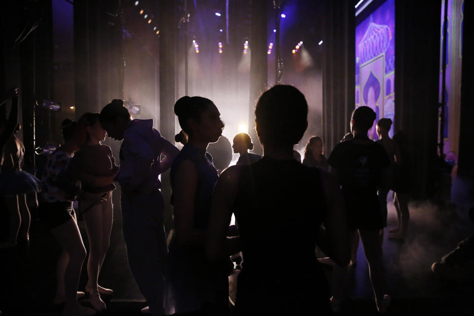 Dancers wait backstage during a rehearsal of Vladimir Issaev's rendition of The Nutcracker ballet on Friday, Dec. 13, 2019, in Fort Lauderdale, Fla. More than 20 dancers of Venezuelan origin were playing various roles on a recent performance of the holiday favorite “The Nutcracker.” Some of these dancers are here seeking asylum after fleeing their crisis-torn nation, which is plagued by shortages of food and medicine. (AP Photo/Brynn Anderson)