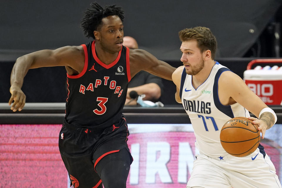 Dallas Mavericks guard Luka Doncic (77) drives around Toronto Raptors forward OG Anunoby (3) during the first half of an NBA basketball game Monday, Jan. 18, 2021, in Tampa, Fla. (AP Photo/Chris O'Meara)