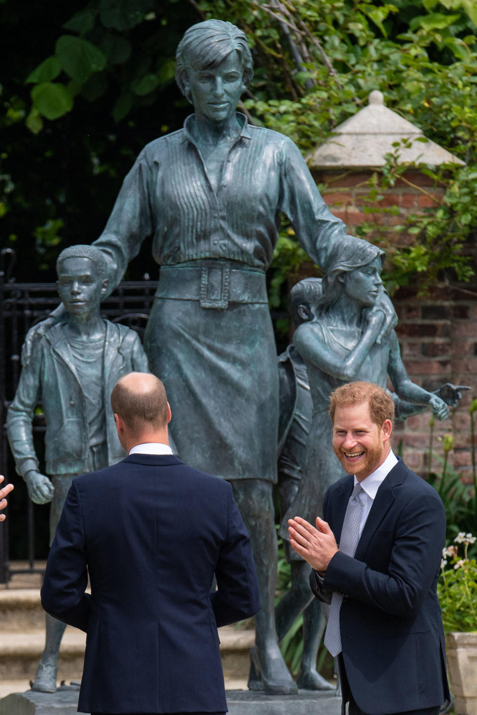 Britain's Prince William, Duke of Cambridge (L) and Britain's Prince Harry, Duke of Sussex unveil a statue of their mother, Princess Diana at The Sunken Garden in Kensington Palace, London on July 1, 2021, which would have been her 60th birthday. - Princes William and Harry set aside their differences on Thursday to unveil a new statue of their mother, Princess Diana, on what would have been her 60th birthday. (Photo by Dominic Lipinski / POOL / AFP) (Photo by DOMINIC LIPINSKI/POOL/AFP via Getty Images)