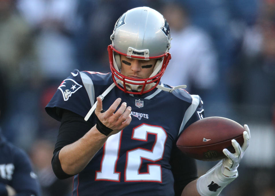 Tom Brady checks his hand before the AFC championship game between the New England Patriots and the Jacksonville Jaguars. (Getty)