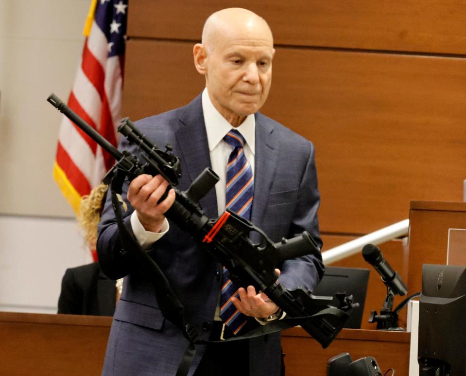 Assistant State Attorney Mike Satz, checks into evidence the weapon used in the Marjory Stoneman Douglas school shooting during the penalty phase of the trial of Nikolas Cruz at the Broward County Courthouse in Fort Lauderdale on Monday, July 25, 2022. Cruz previously plead guilty to all 17 counts of premeditated murder and 17 counts of attempted murder in the 2018 shootings.