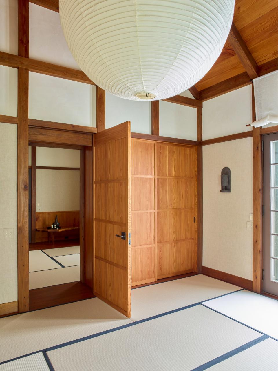 The floor is lined in tatami mats; Akari lantern by Isamu Noguchi.