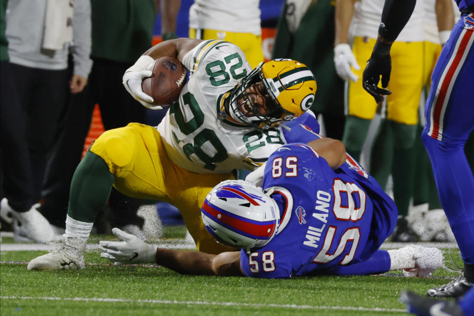 Green Bay Packers running back AJ Dillon (28) is taken down by Buffalo Bills linebacker Matt Milano (58) during the second half of an NFL football game Sunday, Oct. 30, 2022, in Orchard Park. (AP Photo/Jeffrey T. Barnes)