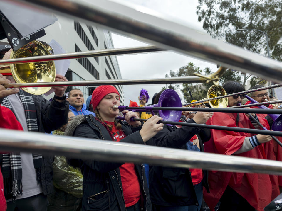 Music teachers perform as they join Los Angeles Unified School District members and Service Employees International Union 99 (SEIU) members outside the LAUSD headquarters in Los Angeles Tuesday, March 21, 2023. Thousands of service workers backed by teachers began a three-day strike against the Los Angeles Unified School District on Tuesday, shutting down education for a half-million students in the nation's second-largest school system. (AP Photo/Damian Dovarganes)