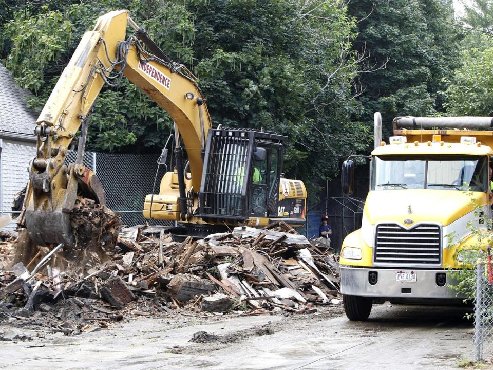 The house of horrors was demolished as spectators cheered from the street (EPA)