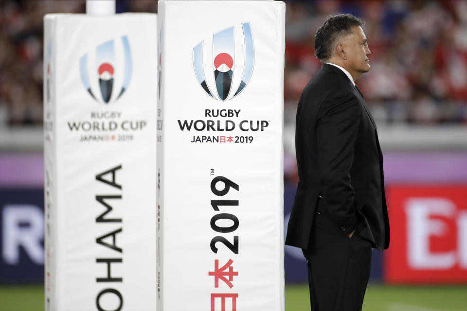 Japan coach Jamie Joseph watches as players warm up before the Rugby World Cup Pool A game at International Stadium between Japan and Scotland in Yokohama, Japan, Sunday, Oct. 13, 2019. (AP Photo/Jae Hong)