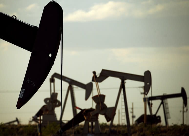 FILE - In this April 24, 2015 file photo, pumpjacks work in a field near Lovington, N.M. With more barrels of oil being pumped monthly from the Permian Basin, New Mexico is among the nation's top producing states. (AP Photo/Charlie Riedel, File)