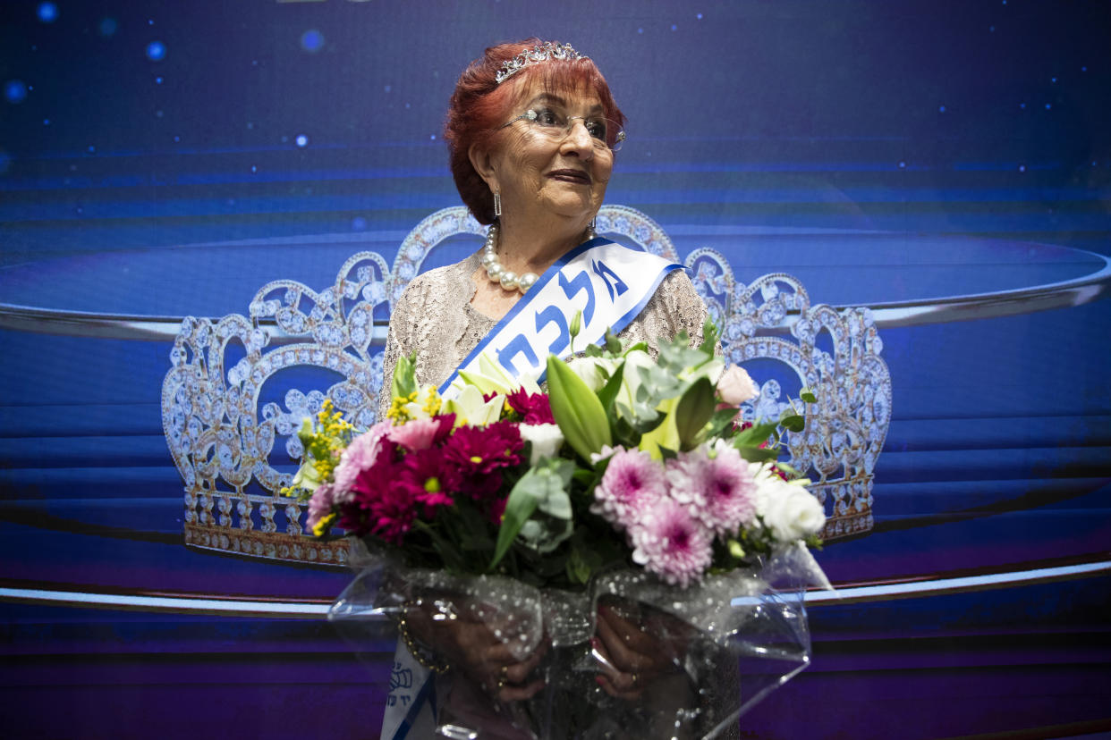 Salina Steinfeld, 86, is crowned 'Miss Holocaust Survivor' poses for a photo during a special beauty pageant honoring Holocaust survivors in Jerusalem, Tuesday, Nov. 16, 2021. Ten contestants participated in the pageant, which was held for the first time since 2019 after being suspended due to the coronavirus pandemic. (AP Photo/Oded Balilty)