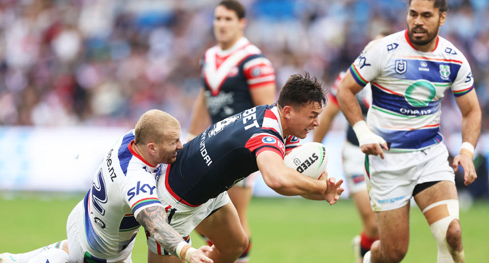 Seen here, Roosters centre Joey Manu is tackled against the Warriors in the NRL.