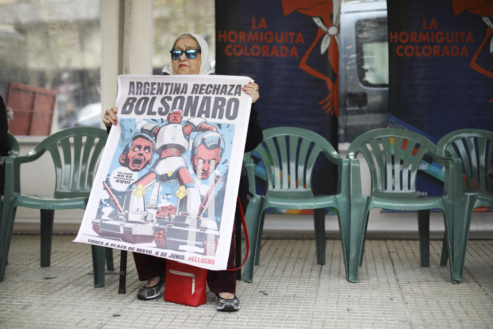 Hebe de Bonafini, President of Madres de la Plaza de Mayo, holds a poster that reads in Spanish "Argentina rejects Bolsonaro" as she protests against the visit of Brazil's President Jair Bolsonaro at Plaza de Mayo, in Buenos Aires, Argentina, Thursday, June 6, 2019.(AP Photo/Natacha Pisarenko)